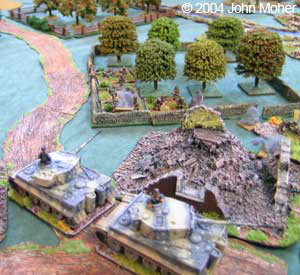 The Tigers edge out of the village under fire from Ivan and his ATRs in the Orchard.