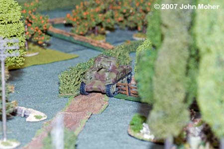 "She's a tight fit Guv" - With part of the road clear the M4A1 Sherman squeezes down it to support No.1 Platoon's advance up the centre.