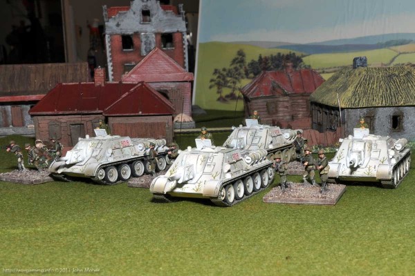Forces of Valor SU-122's emerge from a town Forces of Valor SU-122's emerge from a town with Tank-Rider SMG Platoon escort...