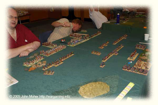 First Moves - the Carthaginians are on the left with Al the Spartan closest, and Benny hiding behind the table! The mass of Expendable Elephants can be seen in the Carthaginian centre, and on the left my Flank Command's Lh(S) and Ax(O) have closed rapidly with the Spanish Infantry skulking in the Scrub. First Moves - the Carthaginians are on the left with Al the Spartan closest, and Benny hiding behind the table! The mass of Expendable Elephants can be seen in the Carthaginian centre, and on the left my Flank Command's Lh(S) and Ax(O) have closed rapidly with the Spanish Infantry skulking in the Scrub.