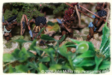 Tribesmen moving through the jungle. Tribesmen moving through the jungle.