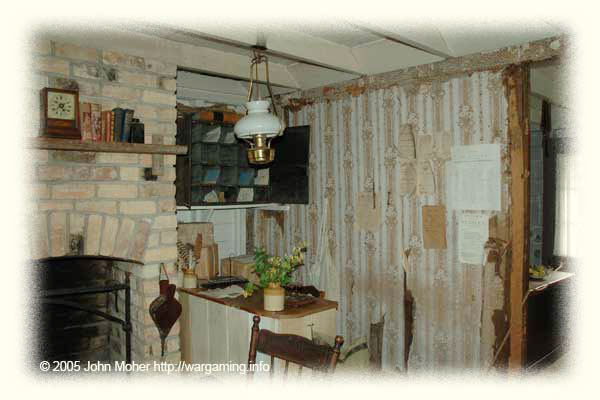 Fencible Cottage Interior - giving an idea of the cramped small size. The photo is taken from the entrance doorway! This particular cottage is serving as the post master's offices and has been modernised (it has had proper actual wallpaper added - probably in the 1920's or later - most cottages were originally eventually wallpapered with newspapers around the 1880s-1890s or turn of the century, or even later) - the internal walls (including those with the neighbours) are all just a single layer of thin timber planking with gaps between the planks, there could be little privacy in these cottages.. There were still people living in a few of these cottages in Auckland as late as the 1940's I believe. Fencible Cottage Interior - giving an idea of the cramped small size. The photo is taken from the entrance doorway! This particular cottage is serving as the post master's offices and has been modernised (it has had proper actual wallpaper added - probably in the 1920's or later - most cottages were originally eventually wallpapered with newspapers around the 1880s-1890s or turn of the century, or even later) - the internal walls (including those with the neighbours) are all just a single layer of thin timber planking with gaps between the planks, there could be little privacy in these cottages.. There were still people living in a few of these cottages in Auckland as late as the 1940's I believe.