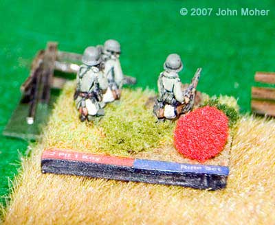 German Defenders, a Rifle Section from the 2nd Platoon of Kompanie 1. The red ball is a marker that denotes the stand has gone 'No Fire' through an unsuccessful reactive fire. German Defenders, a Rifle Section from the 2nd Platoon of Kompanie 1. The red ball is a marker that denotes the stand has gone 'No Fire' through an unsuccessful reactive fire.