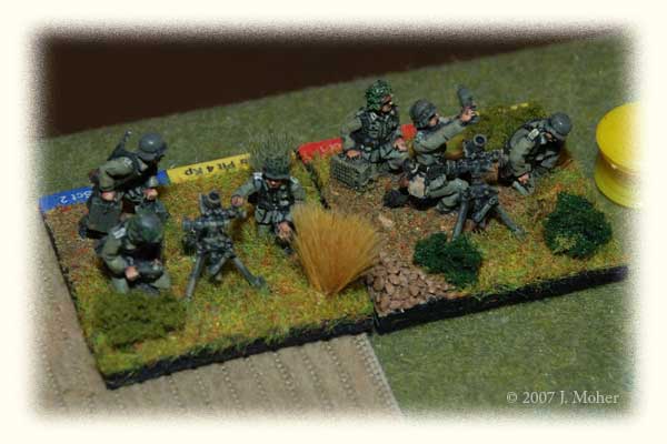 The hard working 8cm Medium Mortar Sections - each representing two real life mortars - even when off table I like to have these modelled with on-table elements on the baseline, it reminds you they are there and also adds a bit more character to the game. The yellow 'tiddly-winks' counters are serving as ammunition stacks (for counting fire missions). The hard working 8cm Medium Mortar Sections - each representing two real life mortars - even when off table I like to have these modelled with on-table elements on the baseline, it reminds you they are there and also adds a bit more character to the game. The yellow 'tiddly-winks' counters are serving as ammunition stacks (for counting fire missions).