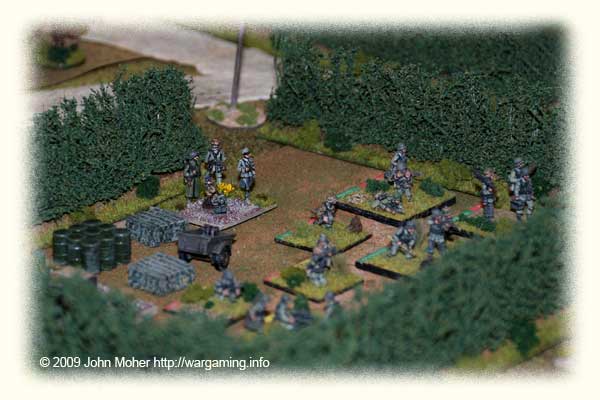 The centre of the German line early in the game, located in an abandoned supply dump in a Bocage Hedge lined field. In the foreground just visible is the MG Platoon, in the centre the 8cm Mortar FO, and to the upper right Platoon 3 (from Kompanie 1). To the rear can be seen the BC's forward command post. This is early in the advance before these troops moved into their assault positions along the bocage in front of them. The centre of the German line early in the game, located in an abandoned supply dump in a Bocage Hedge lined field. In the foreground just visible is the MG Platoon, in the centre the 8cm Mortar FO, and to the upper right Platoon 3 (from Kompanie 1). To the rear can be seen the BC's forward command post. This is early in the advance before these troops moved into their assault positions along the bocage in front of them.